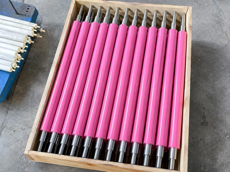 Pink cleaning rollers packed in a wooden crate
