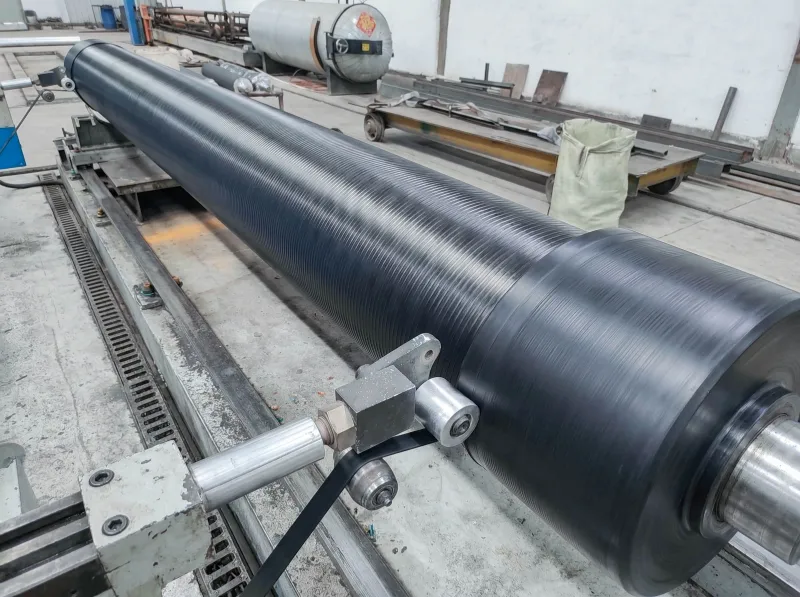 Black grooved squeeze roller being machined on a factory lathe
