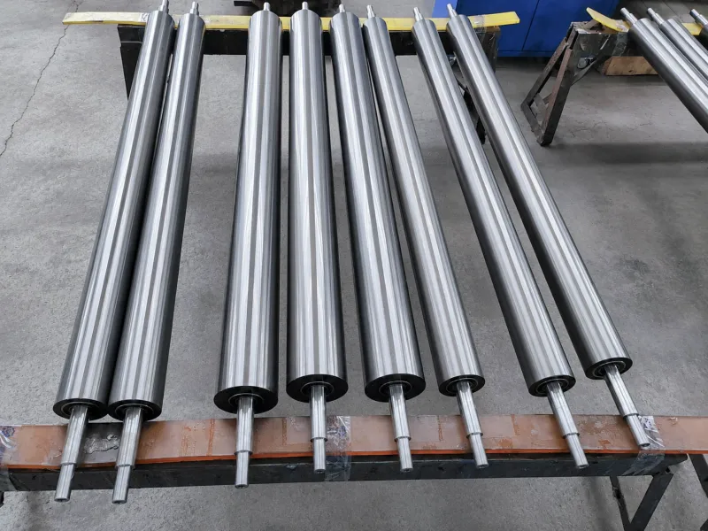 Polished metal guide rollers arranged on a factory stand