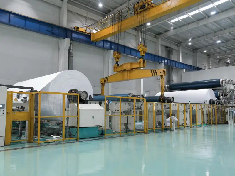 Film passing through rollers on a printing production line