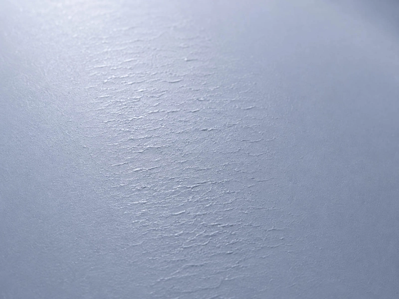 Close-up of uneven matte film surface texture with visible rough marks