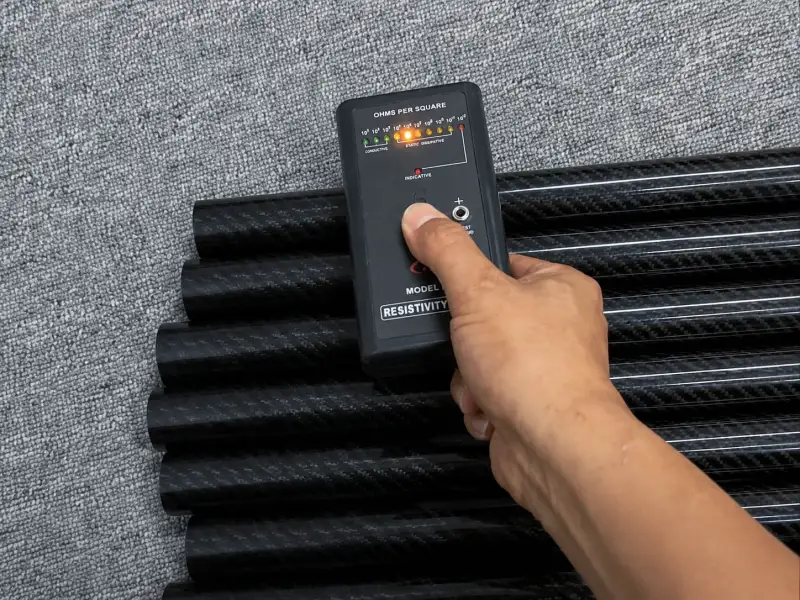Surface resistivity testing on black conductive carbon fiber rollers