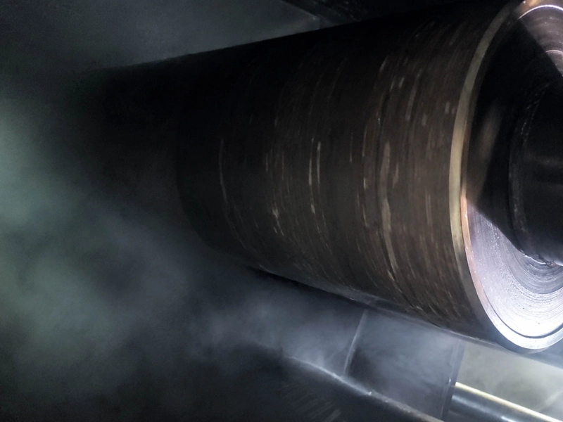 Dark rubber roller installed on tarpaulin calendering production equipment